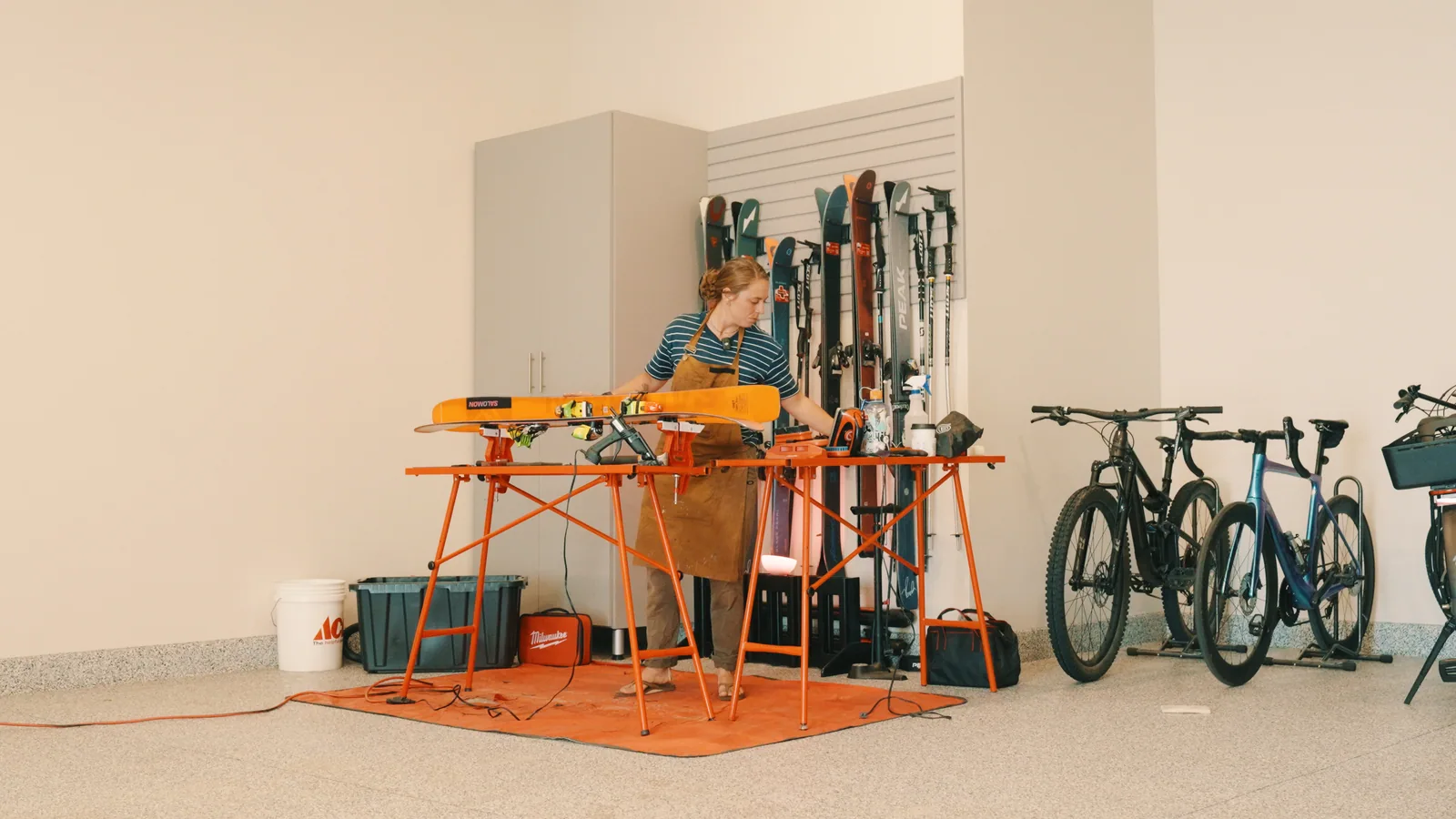 A maker at her workbench in a ski and bike shop.